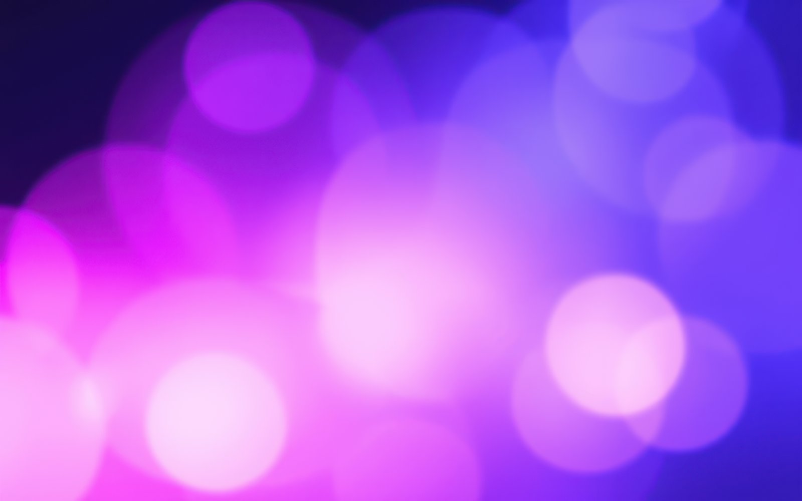 Colorful bokeh lights create a vibrant backdrop at a nighttime event or celebration